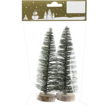 Zwei künstliche Mini-Weihnachtsbäume mit Schneeeffekt auf runden Holzsockeln, in einer transparenten Verpackung.