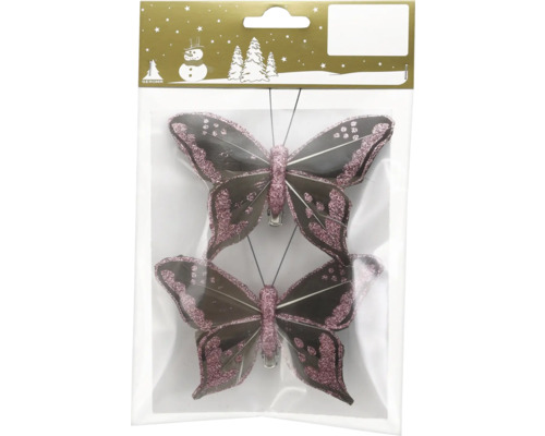 Zwei dekorative Schmetterlings-Clips mit rosa Glitzer und dunklen Federn in der Verkaufsverpackung mit Geroma Logo.