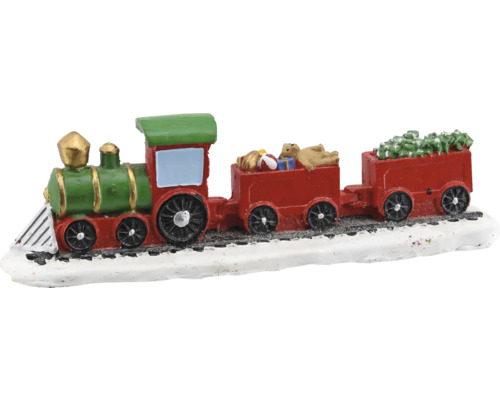 Dekorativer Weihnachtszug mit grüner Lokomotive und roten Waggons beladen mit Geschenken und Tanne auf verschneiten Gleisen.