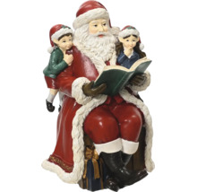 Weihnachtsfigur Weihnachtsmann sitzend und zwei Kindern aus einem Buch vorlesend.