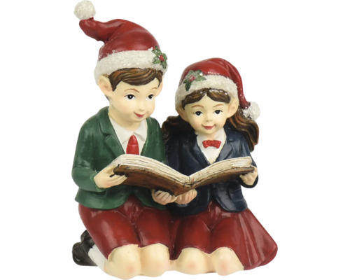 Weihnachtsfigur Bub und Mädchen beim gemeinsamen Lesen in einem Buch, beide tragen Weihnachtsmützen.