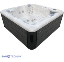 Quadratischer Whirlpool mit zahlreichen Massagejets und dunkler Außenverkleidung in Holzoptik.