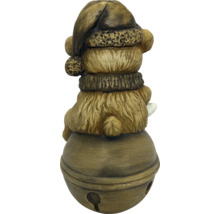 Dekofigur Bär mit Weihnachtsmütze und Schal auf einer Glocke sitzend, aus Polyresin mit Steinoptik.