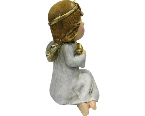 Sitzende Engelsfigur mit goldenem Haar und Herz in den Händen, Weihnachtsdekoration.