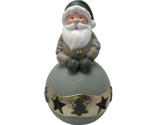 Weihnachtsfigur Weihnachtsmann auf einer Kugel sitzend, mit Bart und Zipfelmütze, Goldband mit Sternenausstanzungen und Tannenbaum.