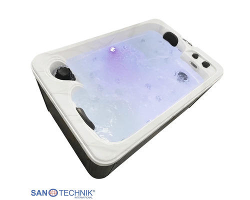 Rechteckiger Whirlpool mit integrierter LED-Beleuchtung, Nackenstützen und dunkler Außenverkleidung.