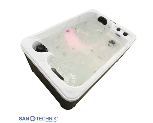 Rechteckiger Whirlpool mit sprudelndem Wasser, rosa LED-Licht, Kopfstützen, dunkler Verkleidung und Sanotechnik International Logo.