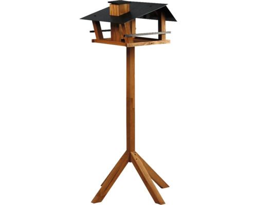 Vogelhaus aus Holz mit Ständer und dunklem Dach.