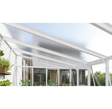 Moderne Terrassenüberdachung aus weißem Aluminium mit lichtdurchlässigem Dach und Glaswänden an einer weißen Ziegelwand.