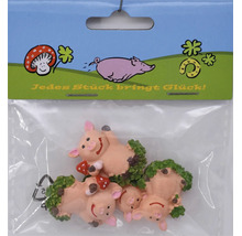 Set mit drei Glücksschweinchen Dekofiguren aus Kunststoff in einer Kunststoffverpackung mit der Aufschrift Jedes Stück bringt Glück.
