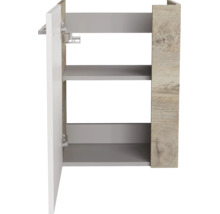Badezimmer-Seitenschrank mit einer Tür und zwei Fächern, Korpus in Holzoptik, weiße Front mit Metallgriff.
