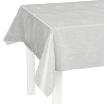 Weiße Tischdecke aus Wachstuch mit Blättermuster auf einem Tisch.