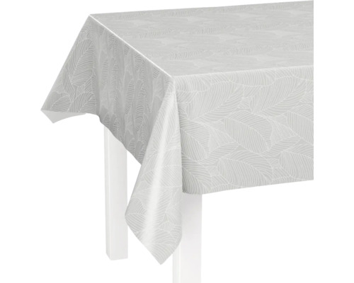 Weiße Tischdecke aus Wachstuch mit Blättermuster auf einem Tisch.