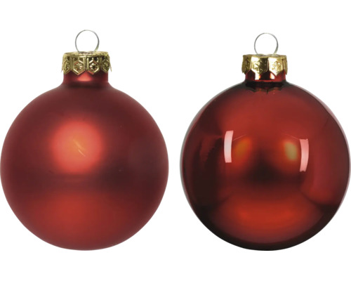Zwei Weihnachtskugeln aus Glas, eine matt und eine glänzend, mit verzierter Kappe und Aufhänger.
