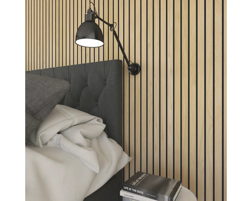 Wandpaneel aus Holzlamellen im Schlafzimmer hinter einem gepolsterten Kopfteil mit einer verstellbaren Wandleuchte.