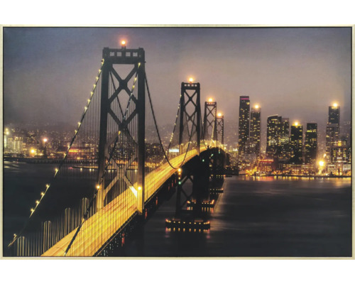 Gerahmtes Wandbild mit beleuchteter Hängebrücke und nächtlicher Stadtsilhouette.