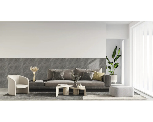 Moderner Wohnbereich mit Wandfliesen in grauer Marmoroptik, Sofa, Sessel und hellen Wänden in einem organisierten, hellen Ambiente.