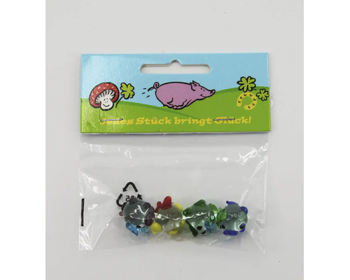 Set aus vier kleinen Glücksbringern aus Glas in einer Kunststoffverpackung mit der Aufschrift Jedes Stück bringt Glück