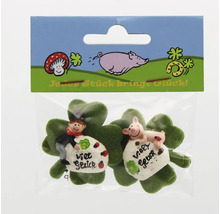 Zwei Glücksbringer mit Schornsteinfeger und Schwein auf Kleeblättern in einer Verkaufspackung.