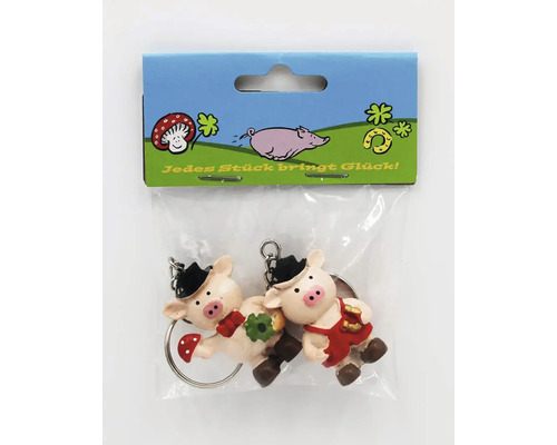 Zwei Schweinchen Schlüsselanhänger als Glücksbringer in einer Verkaufspackung.