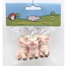 Drei kleine Glücksschweinchen Figuren als Dekoration in transparenter Verpackung