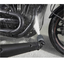 Hochdruckreiniger Düse reinigt Motorradmotor mit Wasserstrahl.
