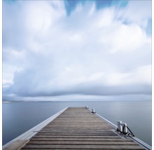 Holzsteg am Meer unter bewölktem Himmel