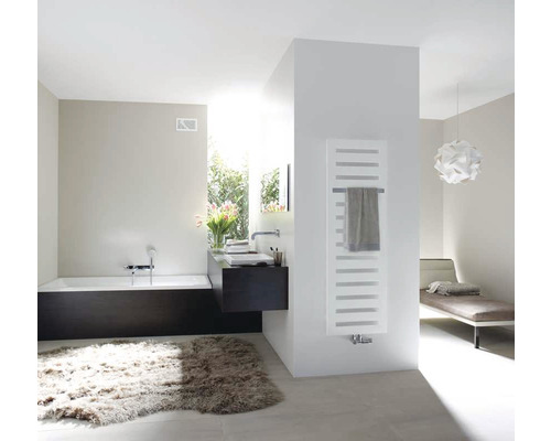 Helles Badezimmer mit Badewanne, Waschbecken, Heizkörper und Teppich