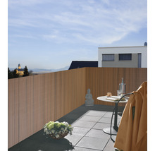 Holzzaun auf einem Balkon mit Tisch, Stuhl und Dekoration