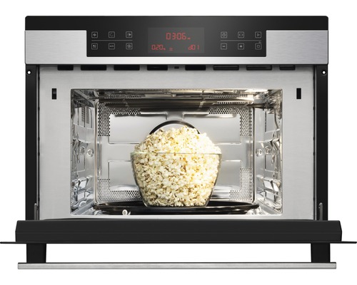 Geöffneter Mikrowellenherd mit einer Schüssel Popcorn im Inneren