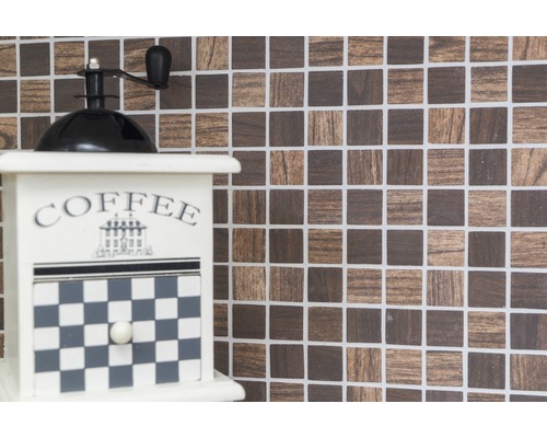 Dekorative Kaffeemühle vor Mosaikhintergrund