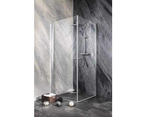 Eckdusche mit Duscharmatur und Handbrause in einem Badezimmer mit grauen Steinwänden.