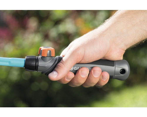 Eine Hand hält einen Gardena Gartenschlauch mit Absperrventil.