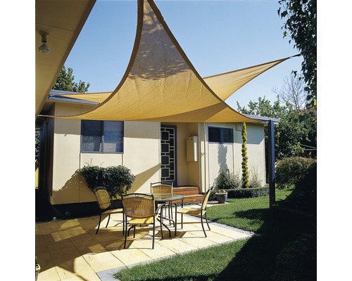 Terrasse mit Sonnensegel, Tisch und Stühlen vor einem Haus