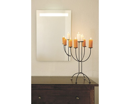 Spiegel mit Beleuchtung und Kerzenständer auf einer Kommode