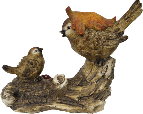 Dekorative Vogelfiguren auf einem Baumstamm mit einem Blatt als Zierde