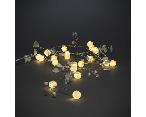 Dekorative Lichterkette mit Blättern und runden Lampen