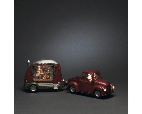 Weihnachtliche Dekoration mit Spieluhr, bestehend aus einem roten Pickup-Truck mit Anhänger, der eine Weihnachtsszene zeigt
