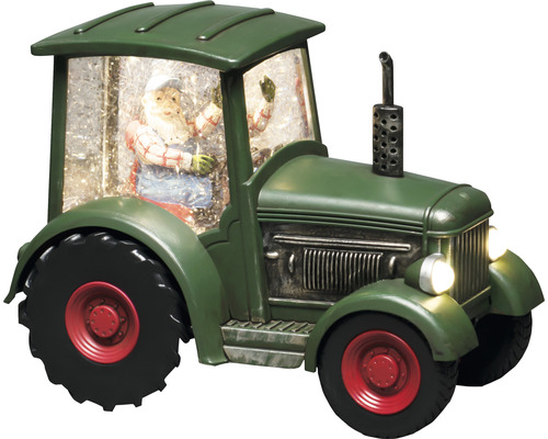 Dekorativer grüner Traktor mit Weihnachtsmannfigur und Schnee