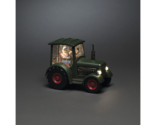 Dekorative Schneekugel mit Weihnachtsmann in einem Traktor
