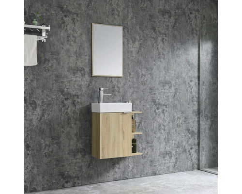 Badezimmer mit Waschtisch, Spiegel und Handtuchhalter an einer grauen Wand