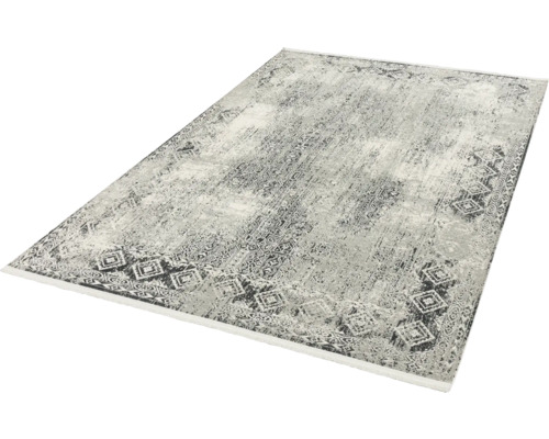 Teppich mit abstraktem Muster und Bordüre mit Rautenmuster