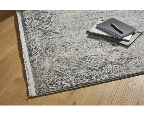 Teppich mit gemustertem Design und Notizblöcken auf Holzboden