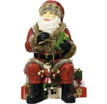 Weihnachtsmannfigur mit Nussknacker-Dekoration und Geschenken