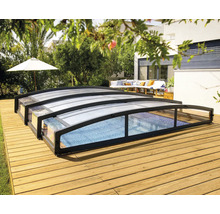 Schwimmbadabdeckung auf einer Holzterrasse in einem Garten.