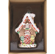 Lebkuchenhausförmiger Christbaumschmuck in einer Schachtel.