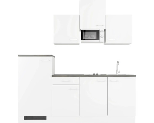 Weiße Küchenzeile mit Spüle, Herd und Mikrowelle