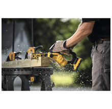 Person sägt Holz mit einer Akku-Kettensäge von Dewalt
