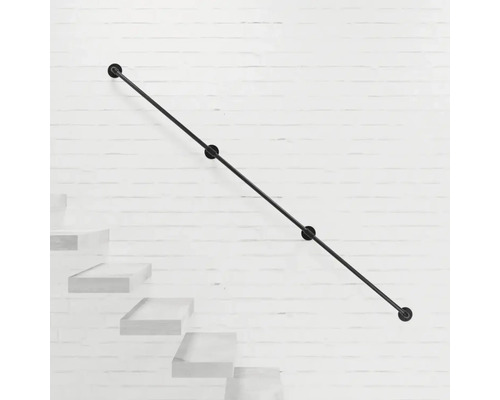 Schwarzer Treppenhandlauf aus Metall an einer weißen Ziegelwand.