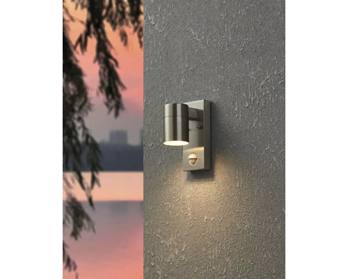 Außenwandleuchte mit Bewegungsmelder an einer Wand montiert.